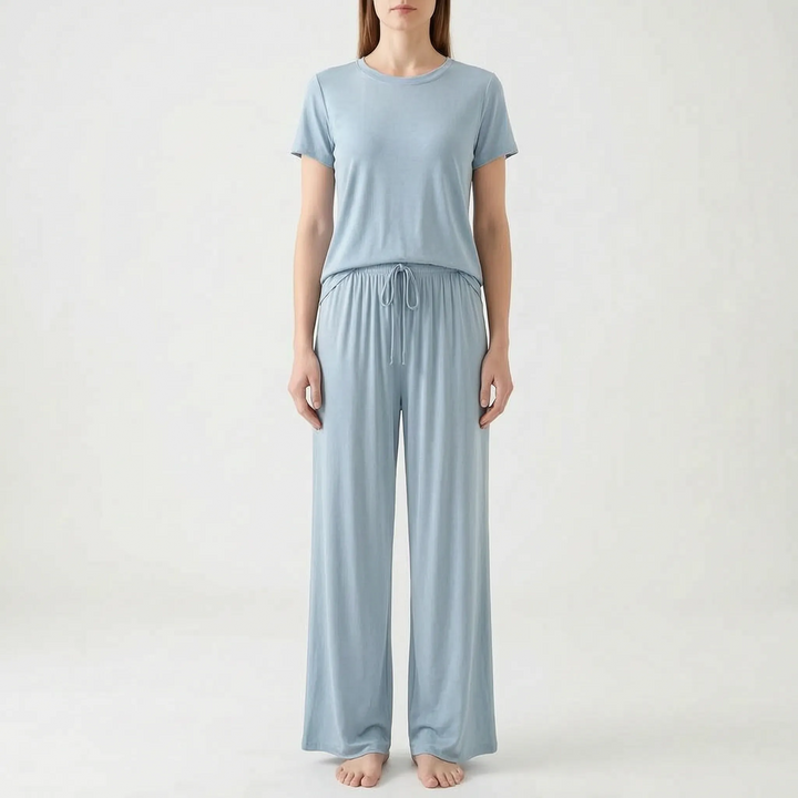 Model standing in the set in light powder blue, with a short-sleeved top and drawstring wide-leg trousers, front view. 12