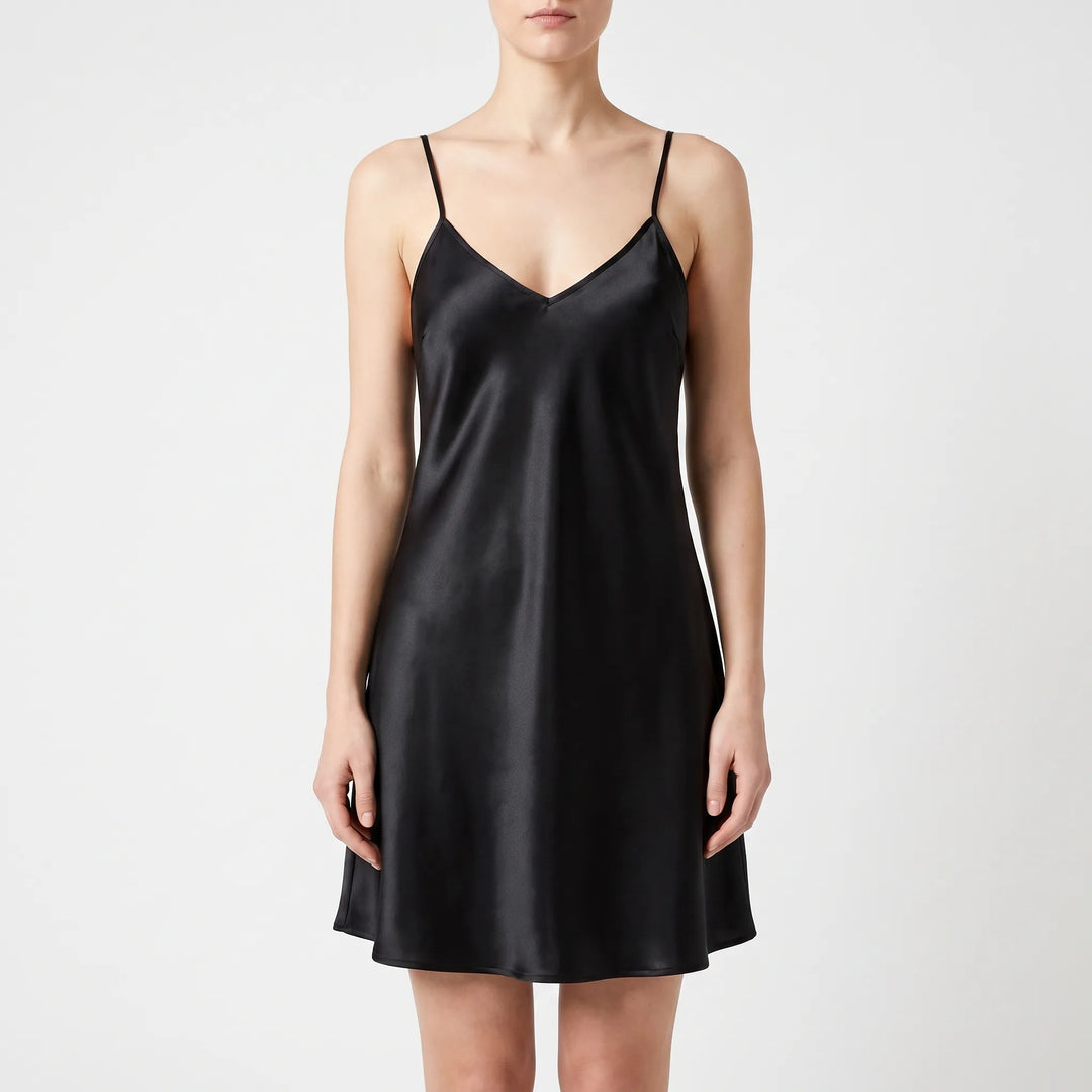 Front view of the same satin slip nightdress in black, worn by a model against a light backdrop. 10