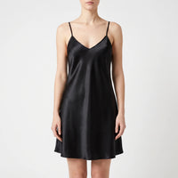 Front view of the same satin slip nightdress in black, worn by a model against a light backdrop. 10