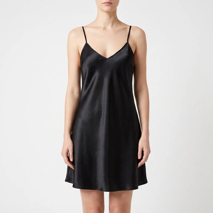 Front view of the same satin slip nightdress in black, worn by a model against a light backdrop. 10