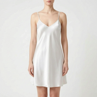 Front view of the slip in an ivory-white shade on a model, with V-neckline, spaghetti straps and a flared hem. 6