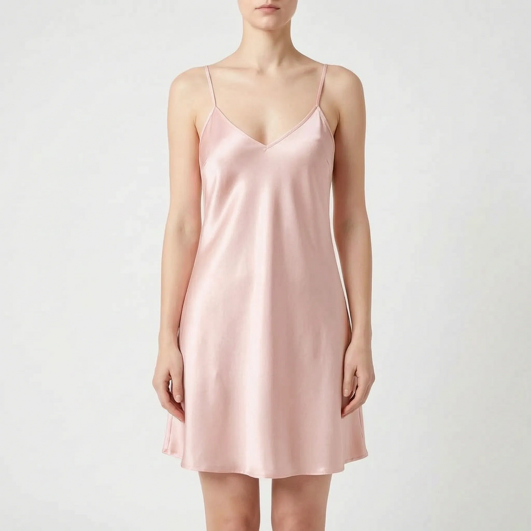 Front view of the same satin slip nightdress in soft pink, worn by a model against a light backdrop. 7