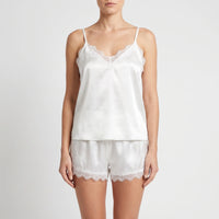 Front view on a model of the white satin cami and shorts, showing the lace-trimmed V-neckline and scalloped lace hems. 2