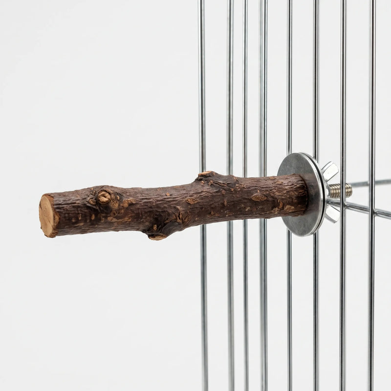 Wooden perch attached to the vertical bars of a wire cage with a metal washer and wing nut, side view. 4