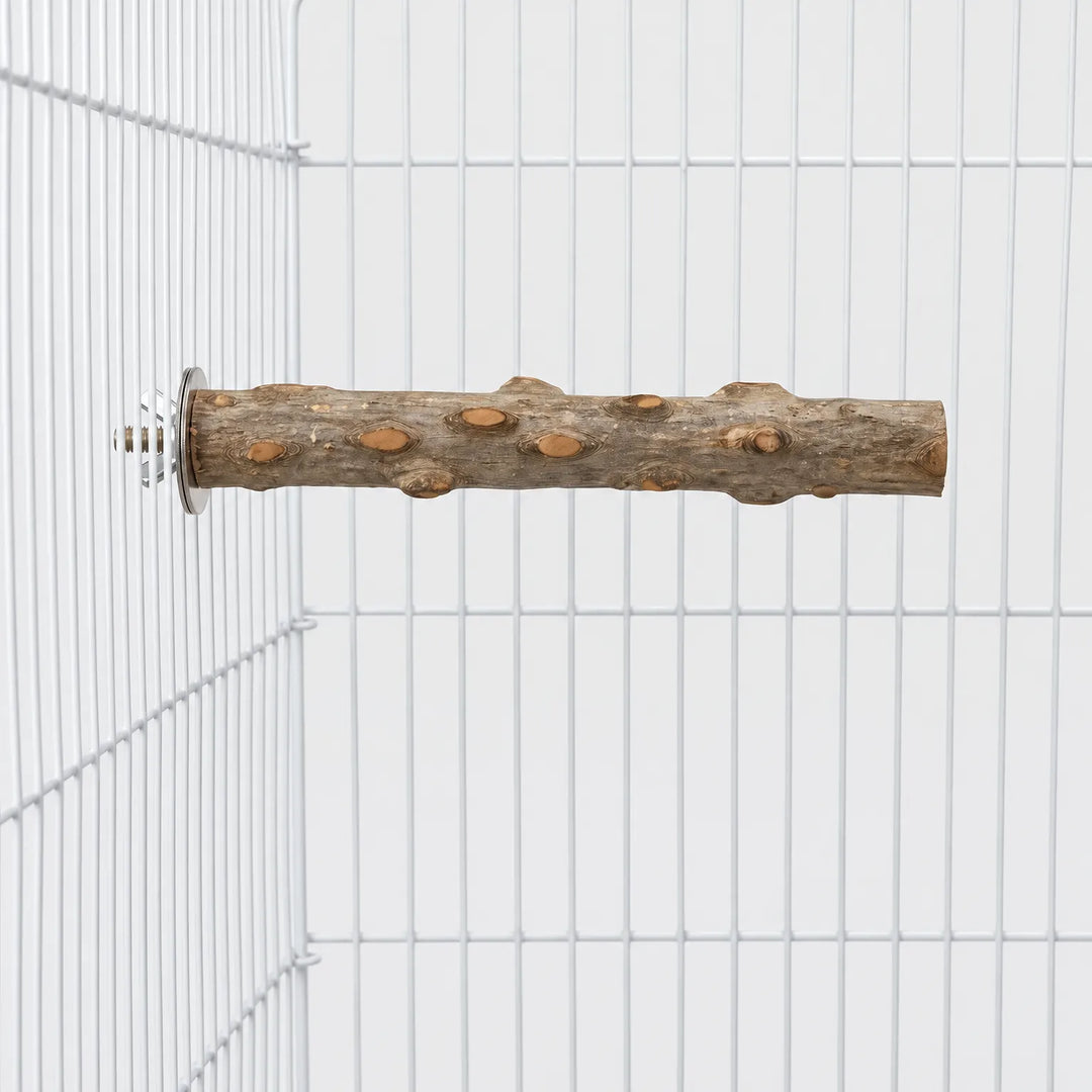 Natural wooden perch with knots, bolted horizontally to the wire of a white cage, seen from the side. 1