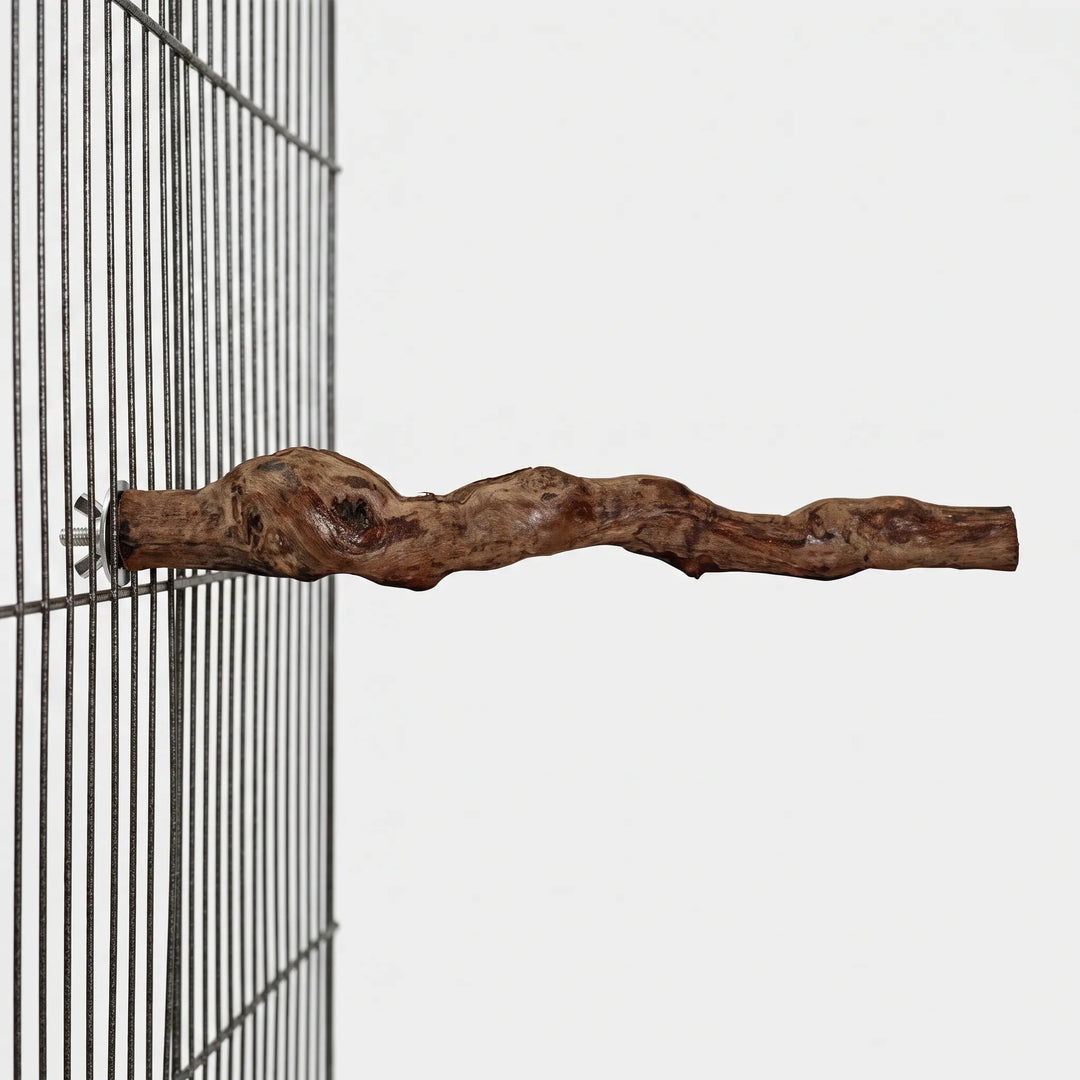 Side view of the twisting wooden perch fixed to a dark wire cage panel by a wing nut and washer. 4