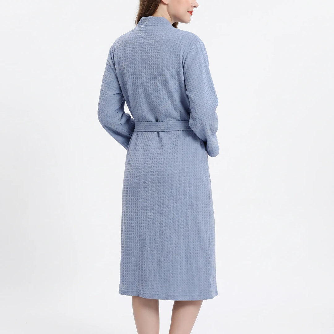 Back view of the blue waffle-textured robe on a model, showing the shawl collar and the belt across the back. 3
