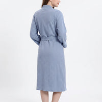 Back view of the blue waffle-textured robe on a model, showing the shawl collar and the belt across the back. 3