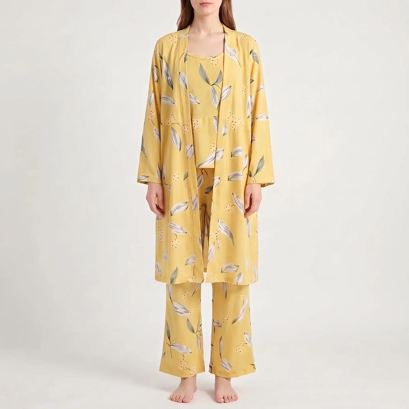 Front view of the set in a yellow colourway with white and green leaf print, worn by a model. 12