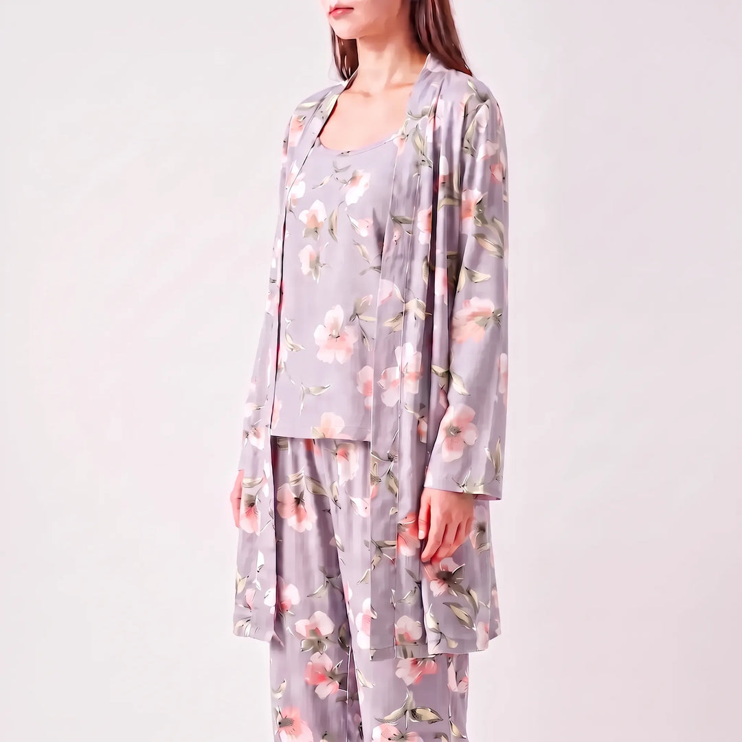 Three-quarter side view of a model in the grey floral robe over the camisole and trousers. 4