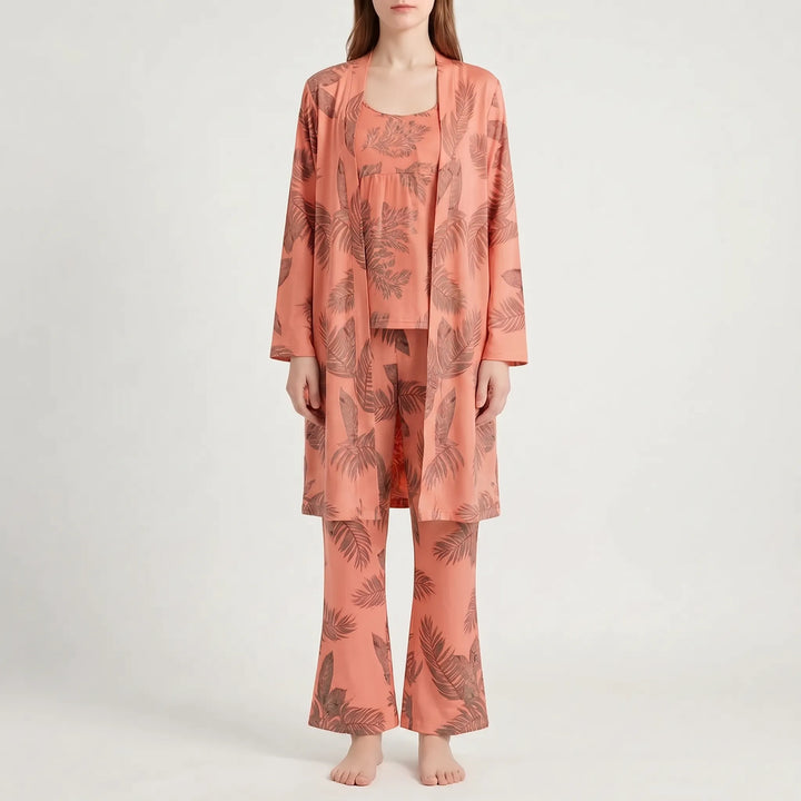 Front view of the set in a coral orange colourway with brown palm-leaf print, worn by a model. 9