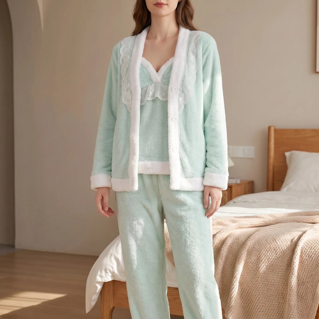 Model in a mint green fleece cardigan, lace-trimmed camisole and trousers with white fuzzy edging, standing in a sunlit bedroom. 1