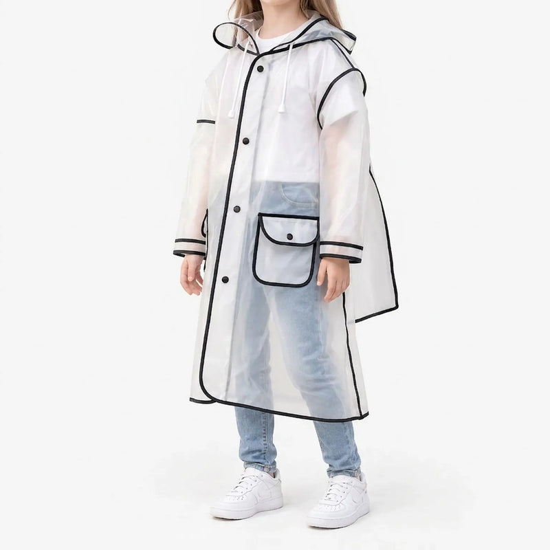 Side view of a girl in the frosted clear raincoat with black trim, snap buttons, a flap pocket and drawstring hood, with white sneakers. 2