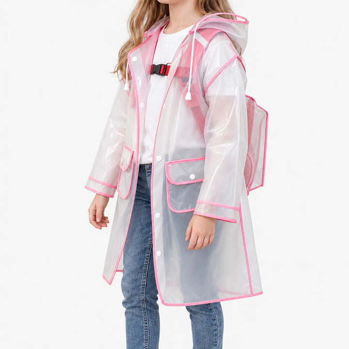 Three-quarter side view of a girl in the frosted raincoat with pink trim, showing the hood cords, chest strap, flap pockets and backpack cover. 5