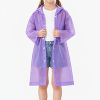Girl in an unfastened translucent purple hooded raincoat over a white t-shirt and denim shorts, showing the snap buttons. 10