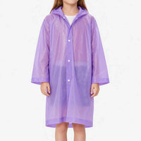 Front view of a girl wearing a translucent purple hooded raincoat closed with white snap buttons, against a plain white background. 2