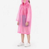 Side view of a girl in a translucent pink hooded raincoat with snap front and white sneakers, on a white background. 5