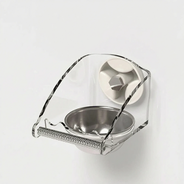 Angled side view of the feeder stuck to a white wall, showing the curved acrylic shield and one suction cup. 4