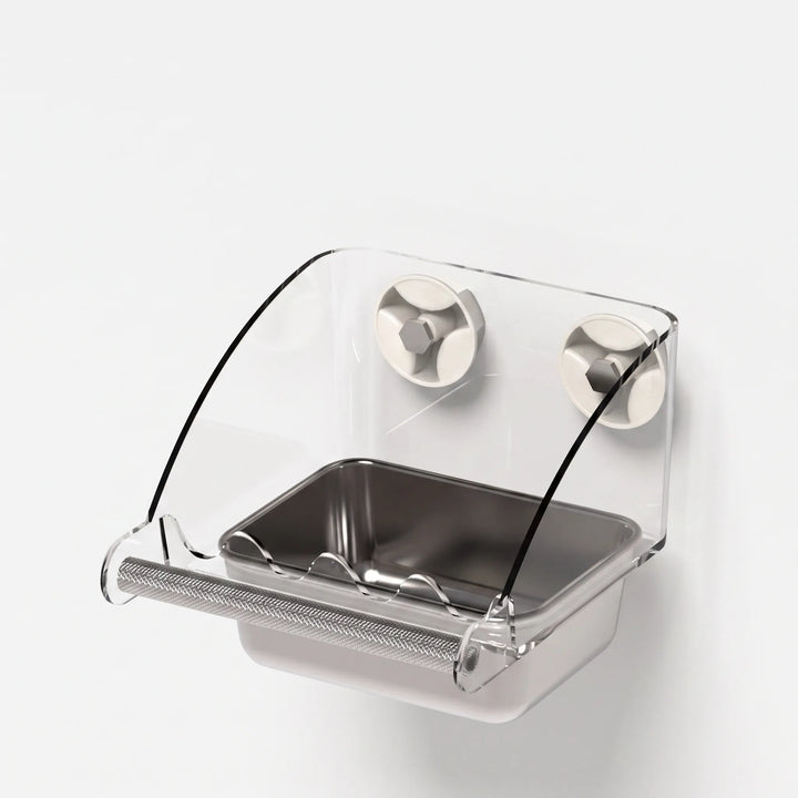 Three-quarter view of the empty feeder with two suction cups, curved clear shield, steel dish and textured perch. 5