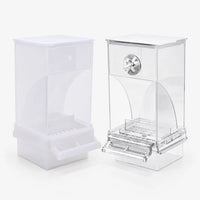 Frosted white and clear acrylic feeders side by side on a plain background, each with a lid, curved seed chute, perch and tray. 1