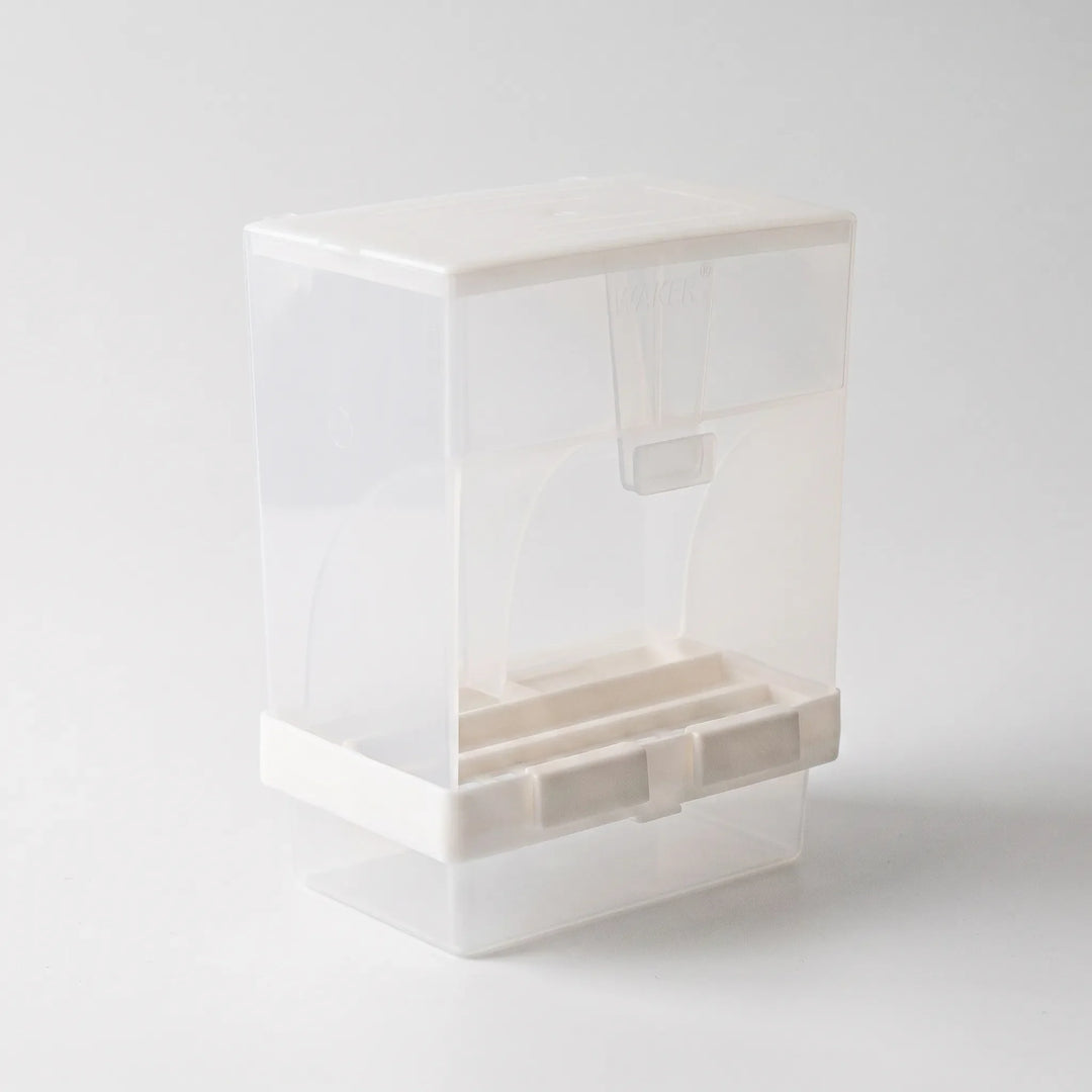 Angled view from the opposite side showing the curved panels, a small hanging scoop beneath the lid and the white base clips. 5
