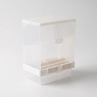 Angled view from the opposite side showing the curved panels, a small hanging scoop beneath the lid and the white base clips. 5