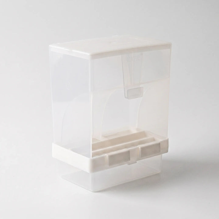 Angled view from the opposite side showing the curved panels, a small hanging scoop beneath the lid and the white base clips. 5