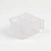 Empty small clear plastic feeder with four compartments, seen from above at an angle with a flat mounting tab at the back. 5