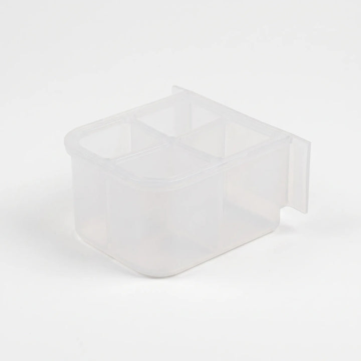 Empty small clear plastic feeder with four compartments, seen from above at an angle with a flat mounting tab at the back. 5