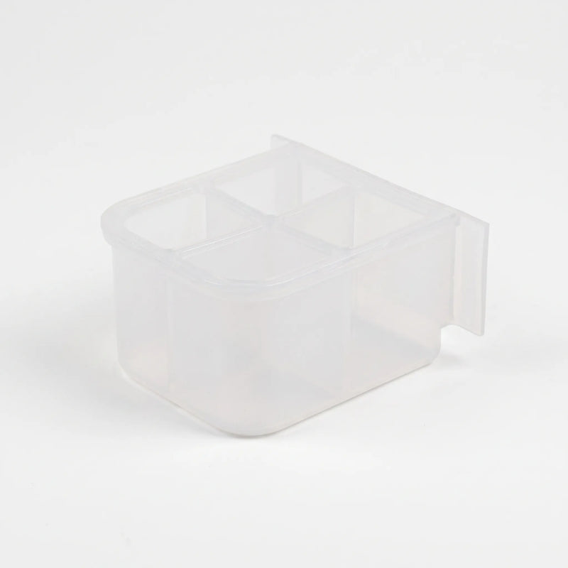 Empty small clear plastic feeder with four compartments, seen from above at an angle with a flat mounting tab at the back. 5