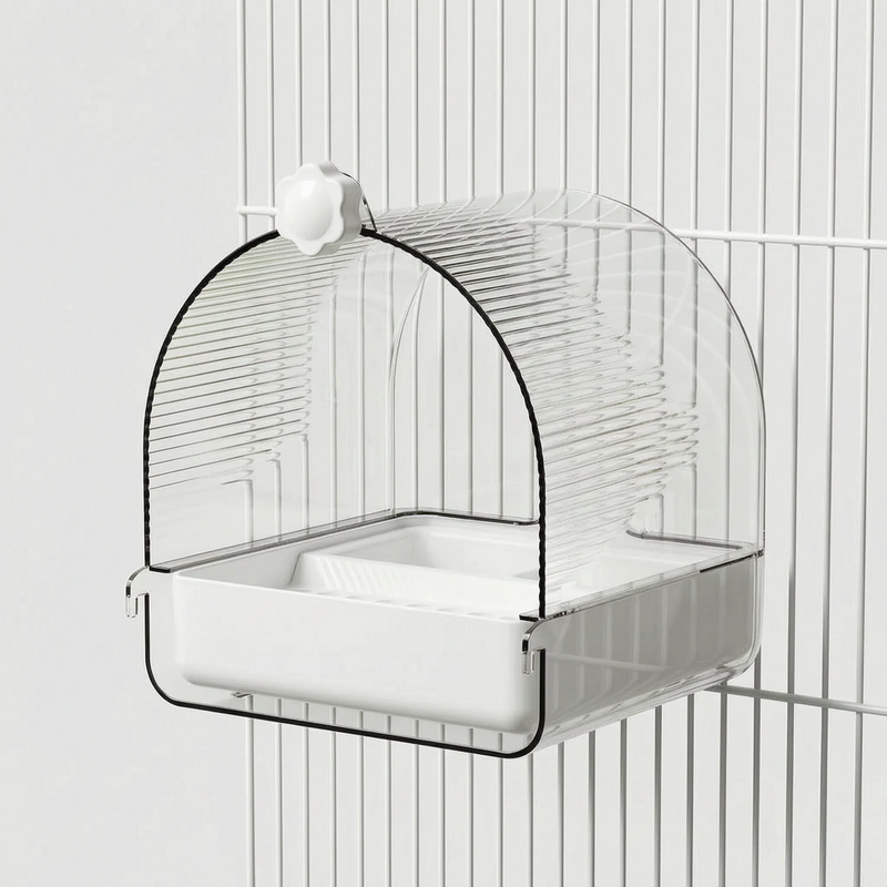 Side view of the bath with a white base and flower-shaped screw knob, fixed to white cage bars. 4