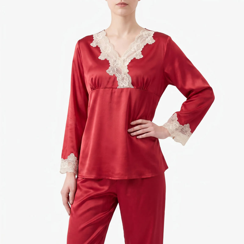 Close front view of the red satin pyjama top on a model, showing the V-neck cream lace trim and lace cuffs. 2