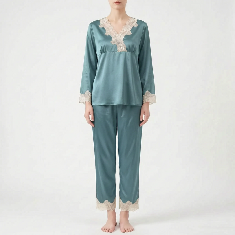 Full-length front view of the pyjama set in teal-blue satin with cream lace trim, worn by a standing model. 7