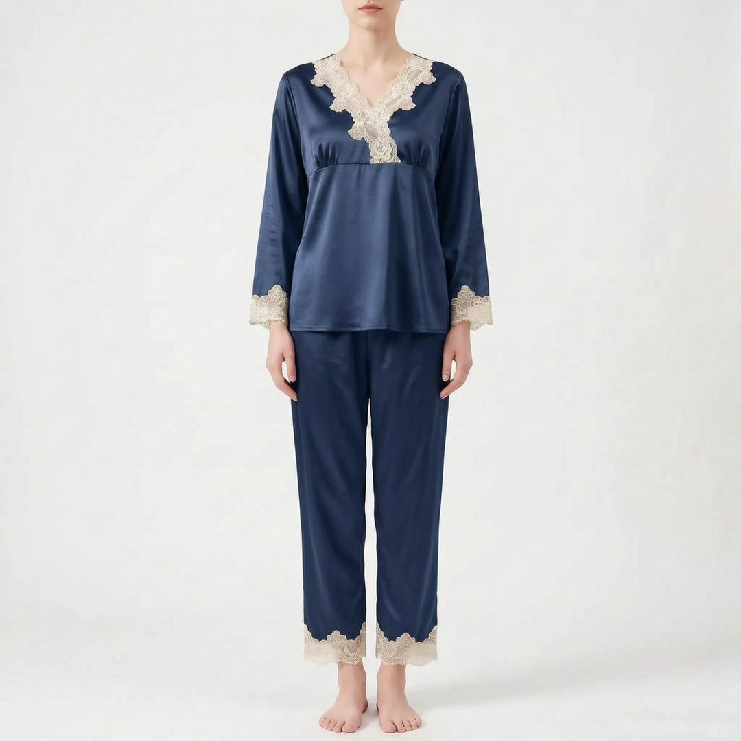 Full-length front view of the pyjama set in navy blue satin with cream lace trim, worn by a standing model. 8