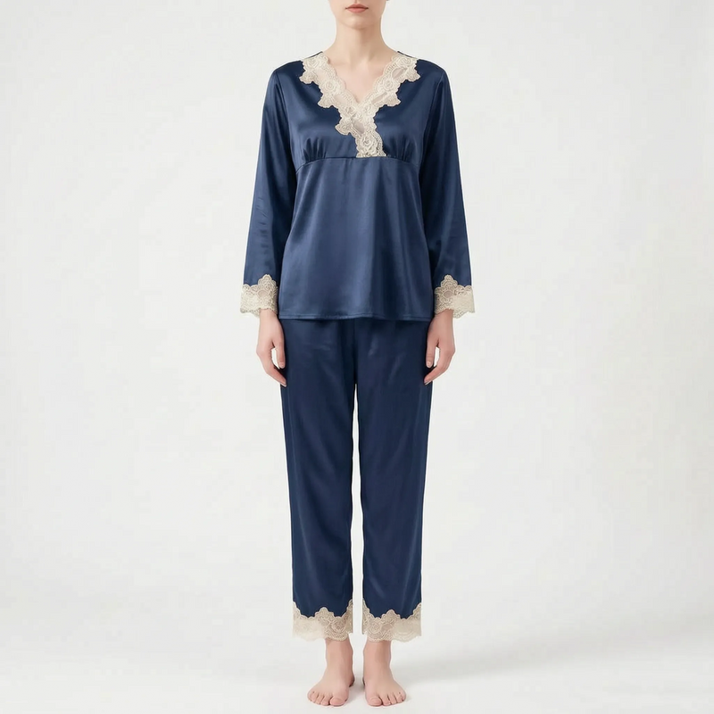 Full-length front view of the pyjama set in navy blue satin with cream lace trim, worn by a standing model. 8