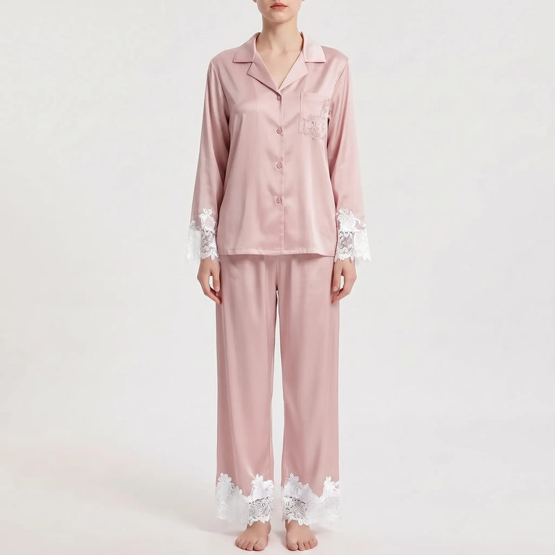 Front view of the pajama set in dusty pink satin with contrasting white floral lace on the sleeve cuffs, pocket and trouser hems. 7