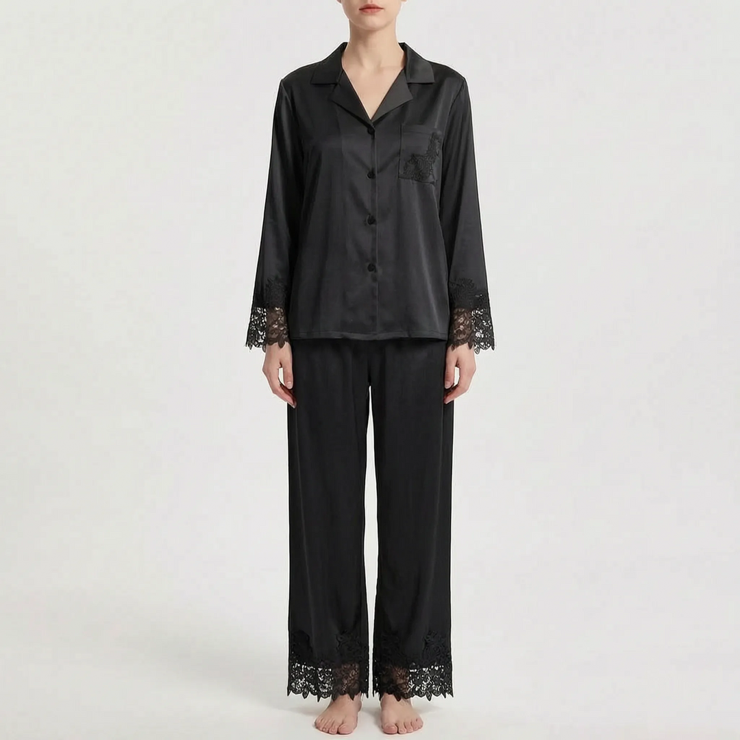 Front view of the pajama set in black satin with matching black floral lace on the sleeve cuffs, pocket and trouser hems. 8
