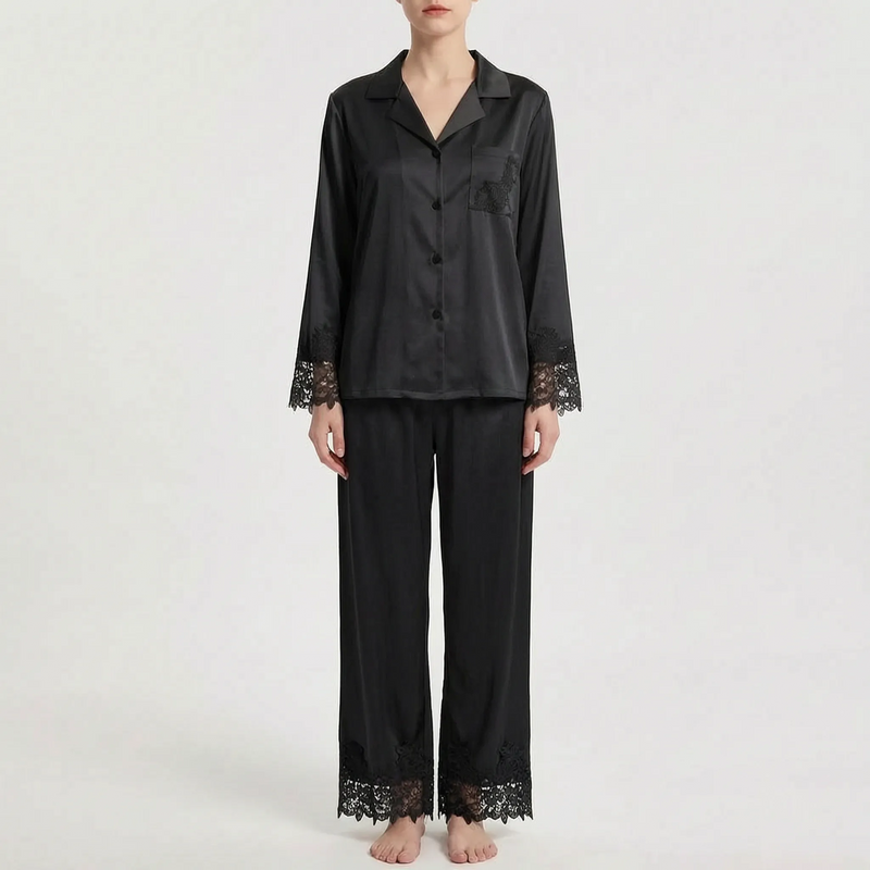 Front view of the pajama set in black satin with matching black floral lace on the sleeve cuffs, pocket and trouser hems. 8