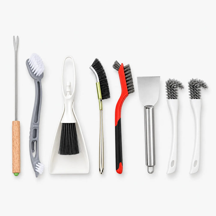 All eight cleaning tools laid out in a row on a white background: forks, brushes, a dustpan set and a scraper. 1