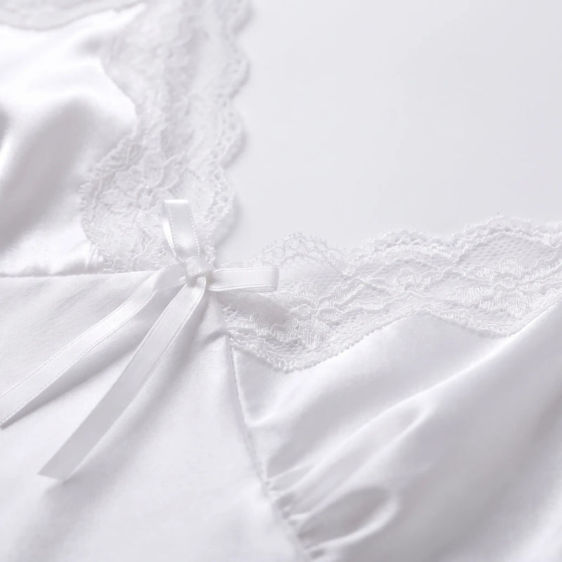 Close-up detail of the white satin bodice with scalloped lace edging and a small satin bow at the centre of the V-neck. 5