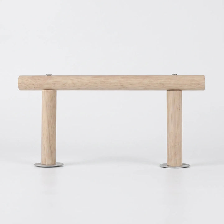 Side view of the wooden perch on a plain white background, a long horizontal rod held up by two short legs with metal washers. 1