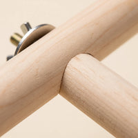 Close-up of the joint where the wooden rods meet, with a metal washer, threaded bolt and wing nut visible. 3
