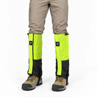 Front view of lime green and black gaiters worn over beige trousers and hiking boots, with drawcord tops and ankle straps. 6