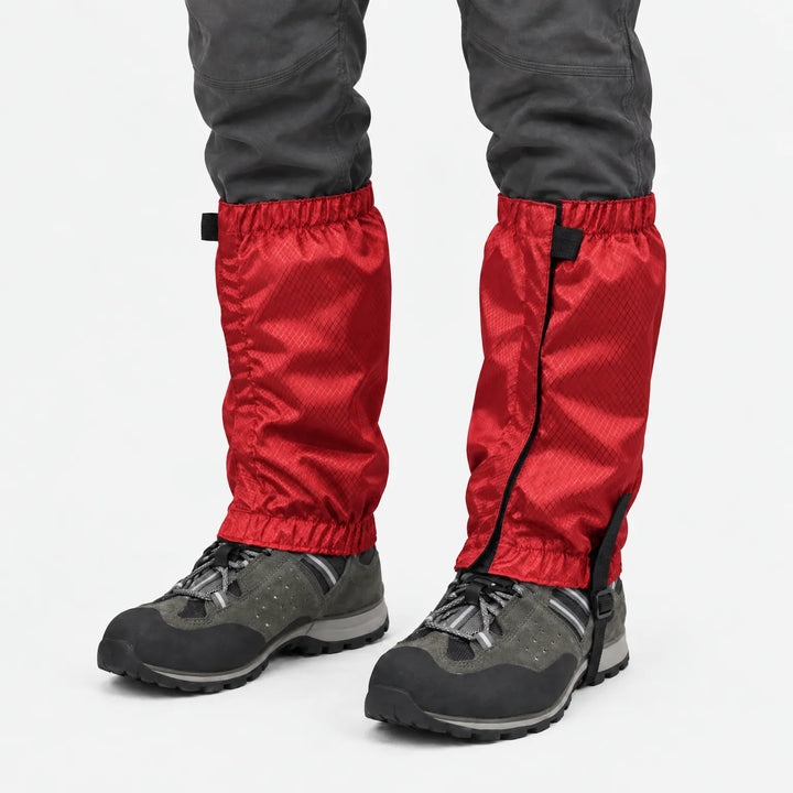 Red ripstop gaiters with elastic cuffs and a securing strap under the boot, worn with grey hiking shoes on white. 7