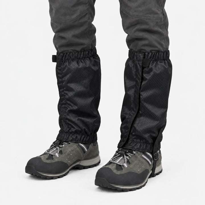 Black ripstop gaiters with front closure and elastic top and bottom, worn over grey hiking shoes on a white background. 9