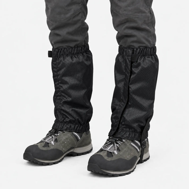 Black ripstop gaiters with front closure and elastic top and bottom, worn over grey hiking shoes on a white background. 9