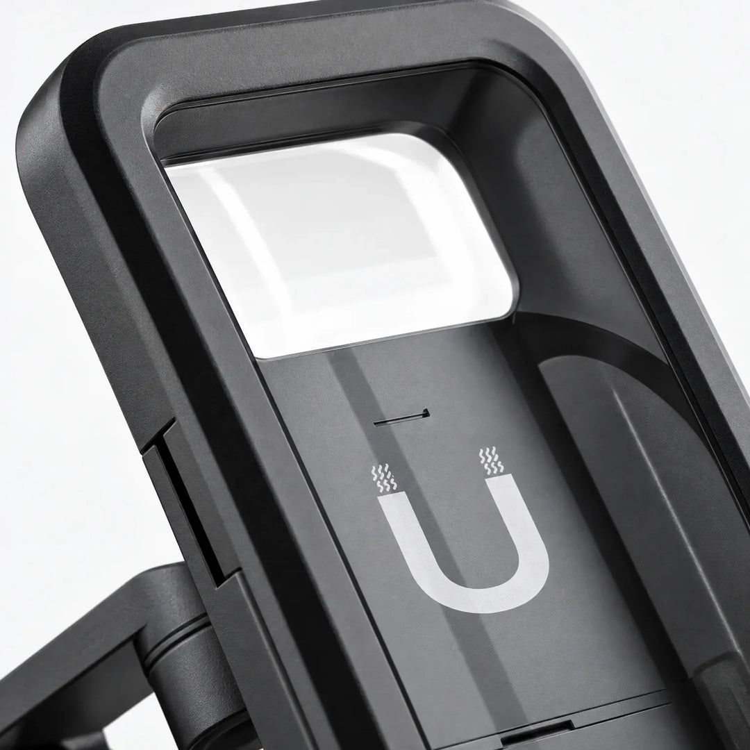 Close-up of the mount's black case, showing the clear top window, magnet symbol on the back plate and the hinged arm. 3