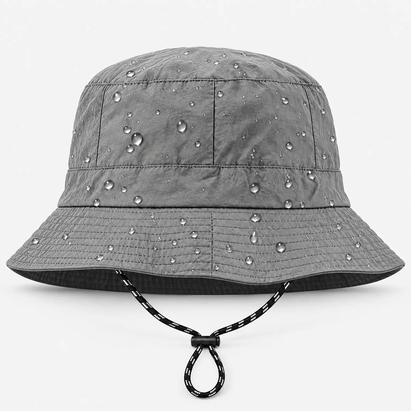 Front view of a grey bucket hat with adjustable black-and-white drawcord, water droplets beading on the fabric. 2