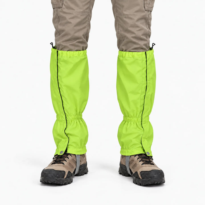 Front view of bright lime green gaiters worn over hiking boots with khaki cargo trousers, showing side zips and snap fasteners. 7