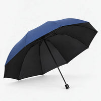 Open navy blue umbrella tilted to show its black underside, ribs and straight black handle on a white background. 2
